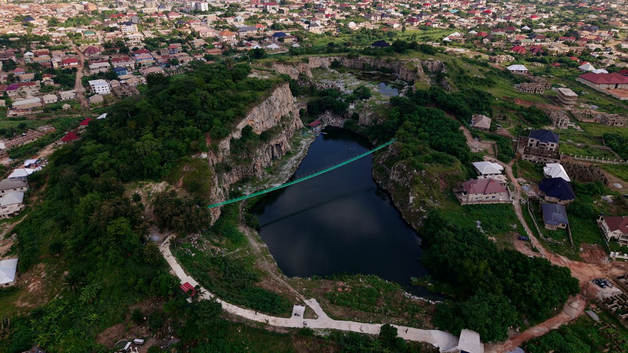 Aerial photo of the existing quarry site at Truba-Kenyase, Ghana, with lake and suspension bridge